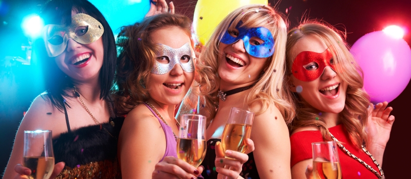 Portrait of happy young girls under masks on the party Portrait of happy young girls under masks on the party