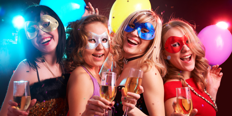 Portrait of happy young girls under masks on the party Portrait of happy young girls under masks on the party